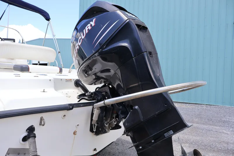 Slide: The Image of 2007 Boston Whaler 180 Dauntless with Mercury outboard motor, docked near blue building. - 13