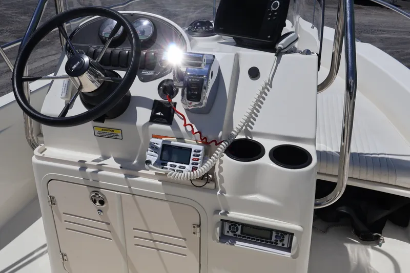 Slide: The Image of 2007 Boston Whaler 180 Dauntless boat console with steering wheel and controls. - 38