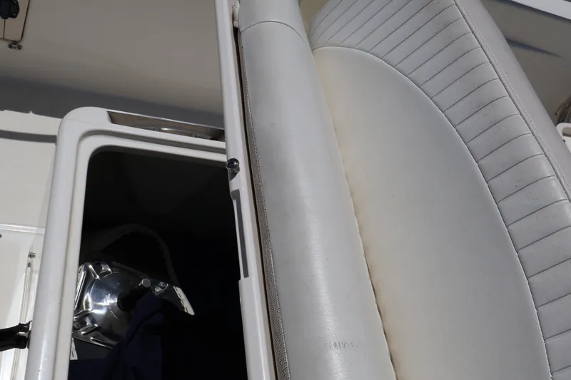 Slide: The Image of 2007 Boston Whaler 180 Dauntless boat seat and storage compartment detail. - 46