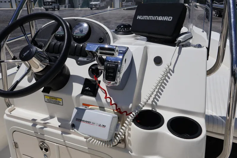 Slide: The Image of 2007 Boston Whaler 180 Dauntless boat console with steering wheel and navigation equipment. - 36