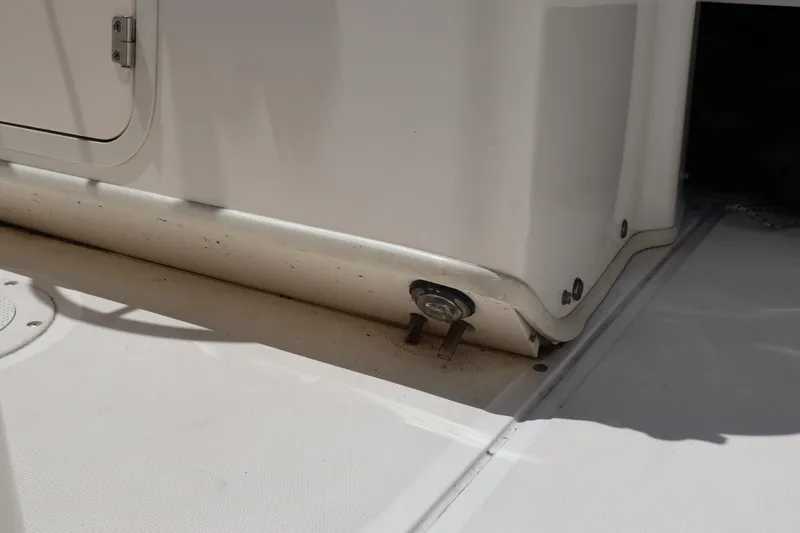 Slide: The Image of 2007 Boston Whaler 180 Dauntless boat interior detail showing storage compartment and deck. - 44