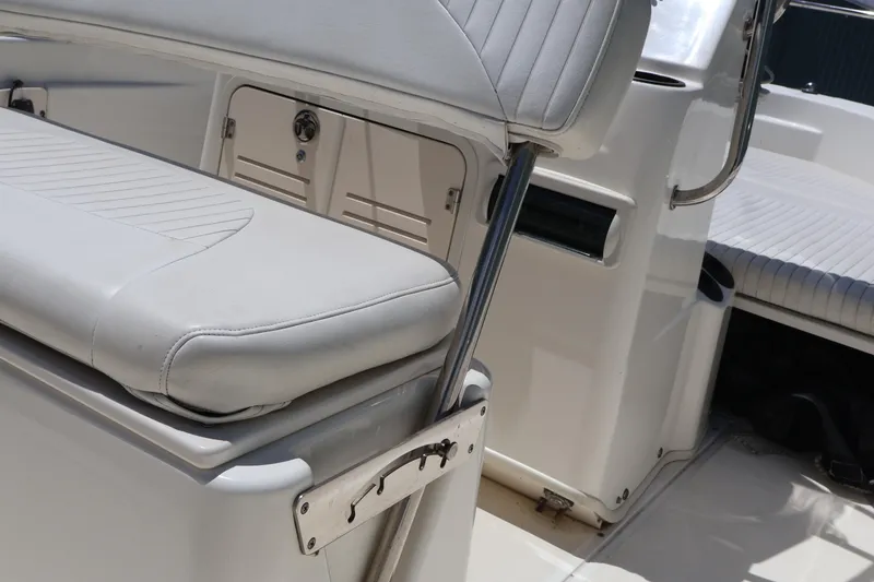 Slide: The Image of 2007 Boston Whaler 180 Dauntless boat interior with cushioned seating and storage compartments. - 47