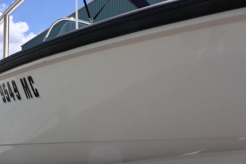 Slide: The Image of 2007 Boston Whaler 180 Dauntless boat side view with registration number. - 12