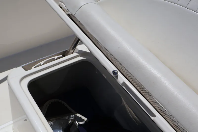 Slide: The Image of Storage compartment on a 2007 Boston Whaler 180 Dauntless boat, featuring cushioned seating. - 45