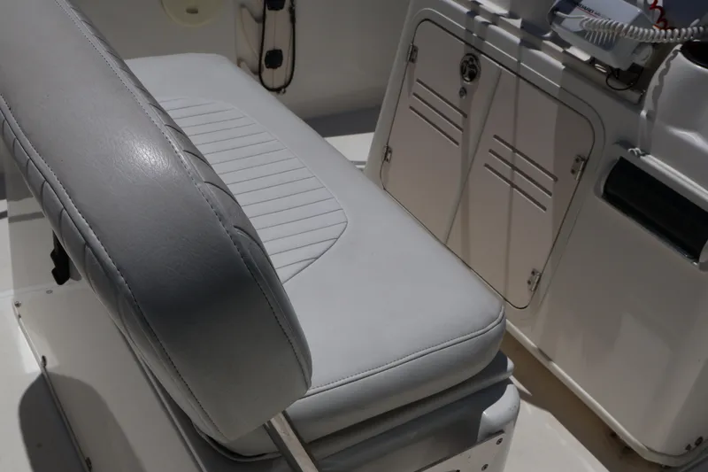 Slide: The Image of 2007 Boston Whaler 180 Dauntless boat interior with cushioned seating and storage compartments. - 43