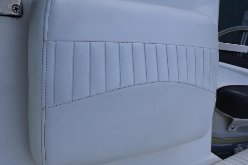 Slide: The Image of White cushioned seat detail on a 2007 Boston Whaler 180 Dauntless boat. - 60