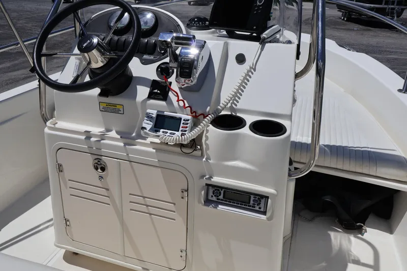 Slide: The Image of 2007 Boston Whaler 180 Dauntless boat console with steering wheel and navigation equipment. - 37