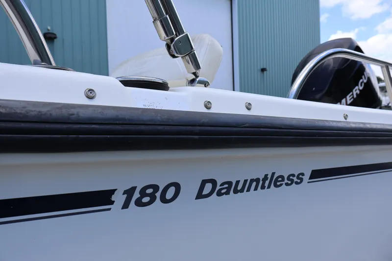 Slide: The Image of 2007 Boston Whaler 180 Dauntless boat side view with Mercury engine. - 10