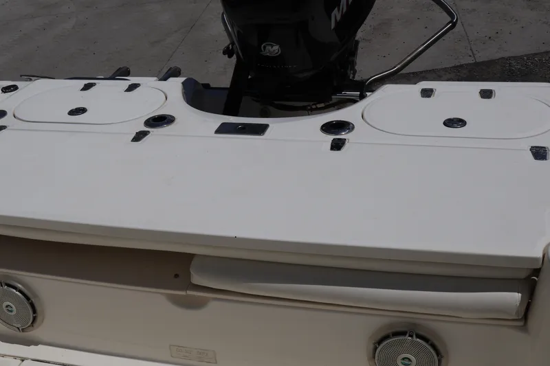 Slide: The Image of 2007 Boston Whaler 180 Dauntless boat deck with storage compartments and motor. - 48