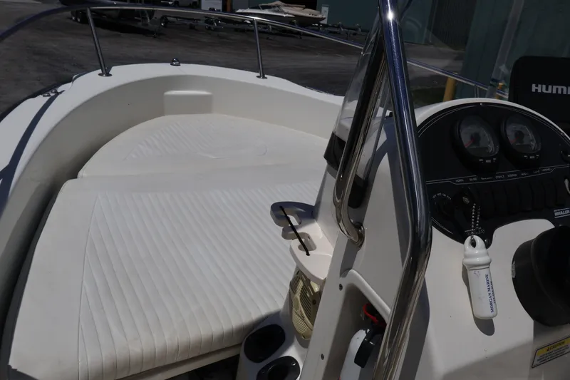 Slide: The Image of 2007 Boston Whaler 180 Dauntless boat interior with steering console and cushioned seating. - 26