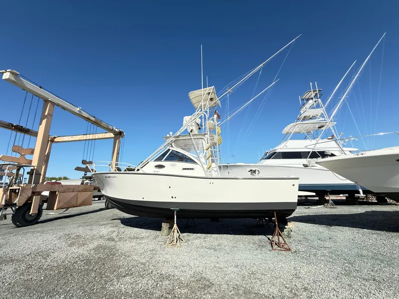 Slide: The Image of 2001 Albemarle 280 Express Sport Fisherman boat on stands, clear sky background. - 4