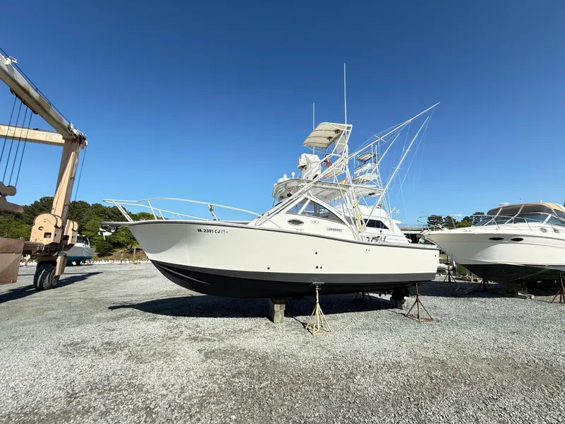 The Image of 2001 Albemarle 280 Express Sport Fisherman boat on gravel lot under clear blue sky. - 0