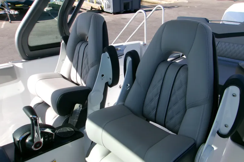 Slide: The Image of 2026 Monterey Elite 25 SD boat interior with luxurious gray seating and modern controls. - 7