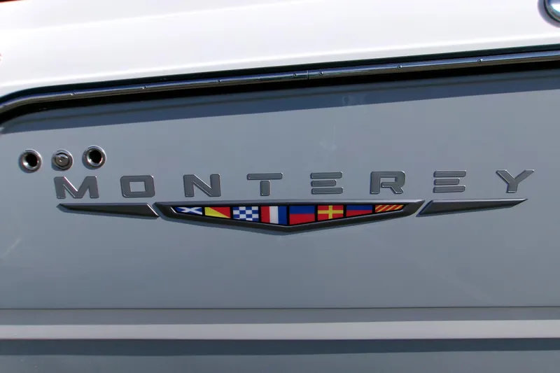 Slide: The Image of 2026 Monterey Elite 25 SD boat logo with nautical flag design. - 16