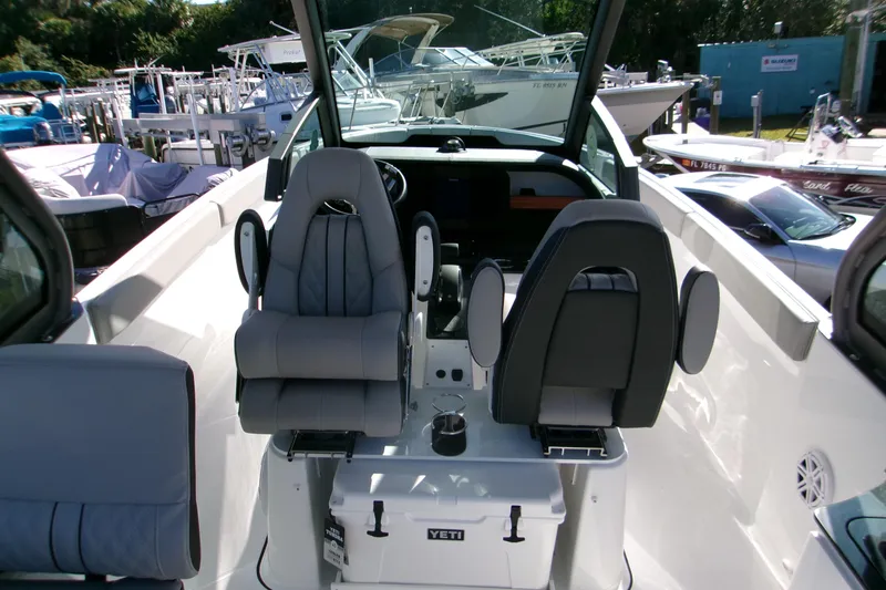 Slide: The Image of 2026 Monterey Elite 25 SD boat interior with modern seating and Yeti cooler. - 18