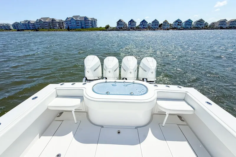 Slide: The Image of 2022 Onslow Bay 41 Tournament boat with four Mercury engines on a sunny waterfront. - 29