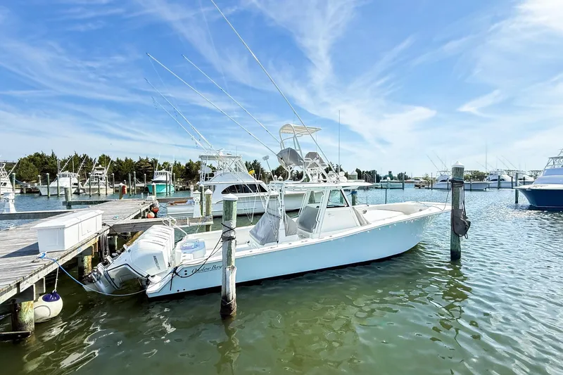 Slide: The Image of 2022 Onslow Bay 41 Tournament boat docked at marina under clear blue sky. - 44