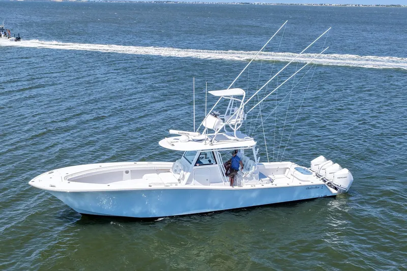 Slide: The Image of 2022 Onslow Bay 41 Tournament boat cruising on open water with fishing rods. - 3