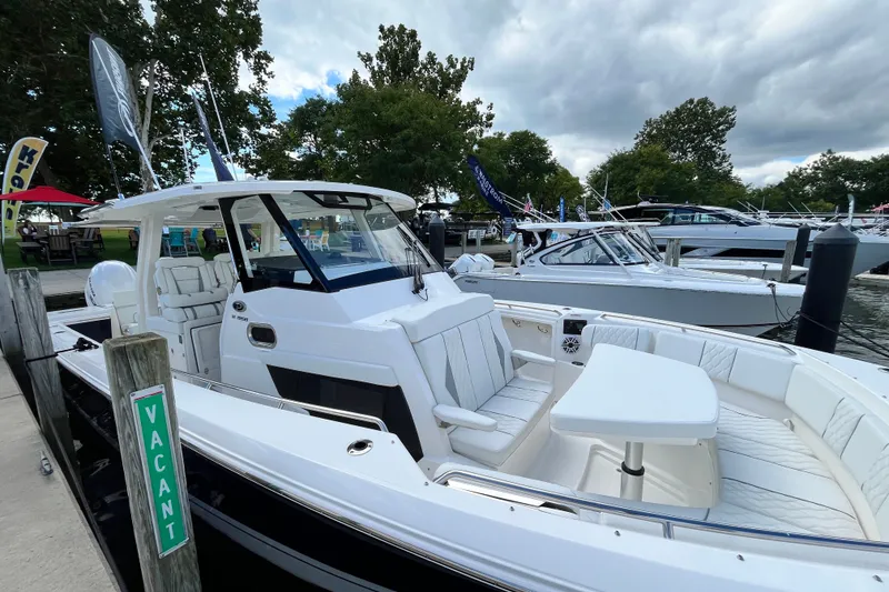 The Image of 2027 Pursuit S 358 Sport boat docked, featuring sleek design and spacious seating. - 0