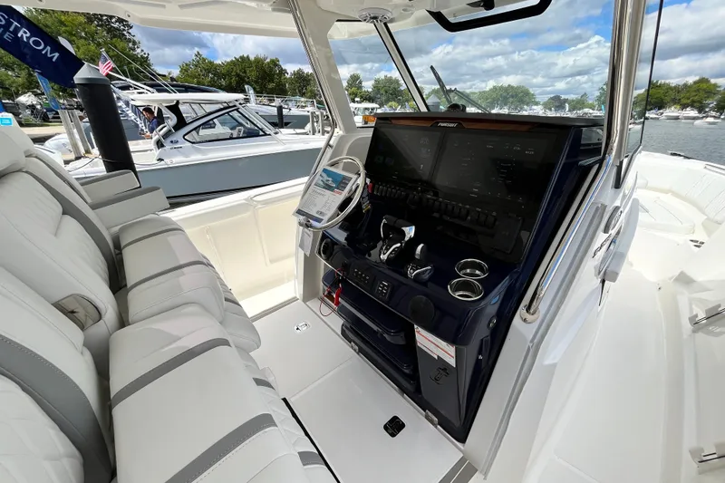 Slide: The Image of Interior view of 2027 Pursuit S 358 Sport boat with modern dashboard and seating. - 11