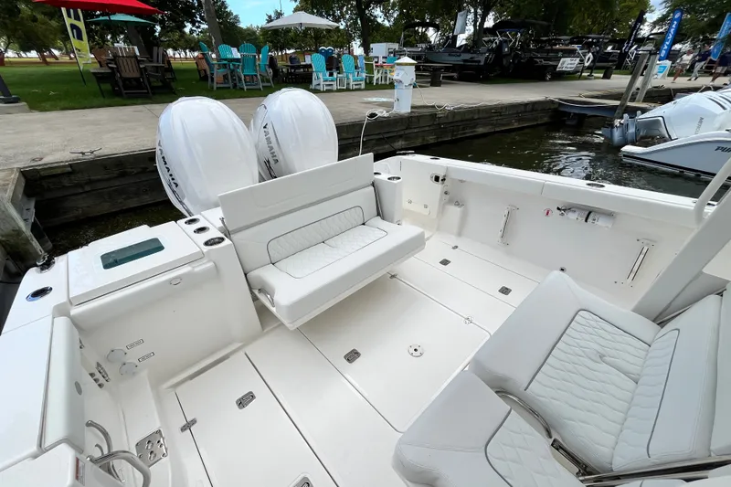 Slide: The Image of 2027 Pursuit S 358 Sport boat interior with seating and twin Yamaha engines at dock. - 5