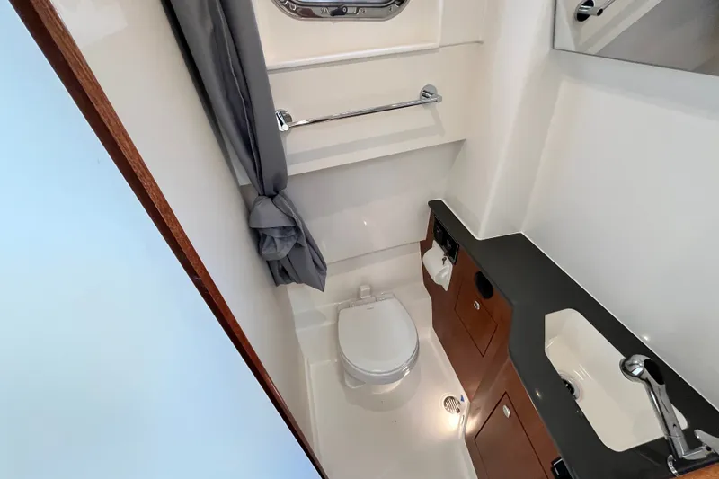 Slide: The Image of Modern bathroom interior of 2027 Pursuit S 358 Sport boat, featuring toilet and sink. - 13