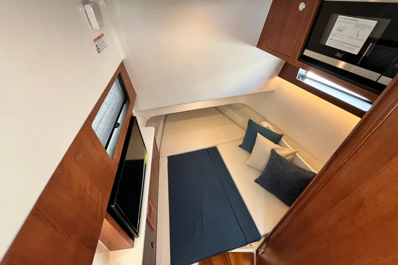 Slide: The Image of Interior cabin of 2027 Pursuit S 358 Sport boat with cozy seating and modern amenities. - 14
