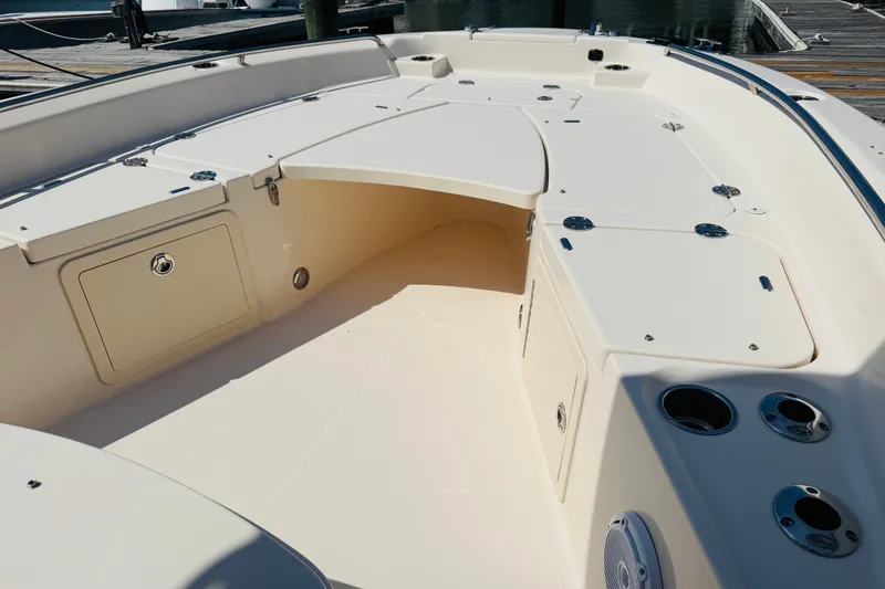Slide: The Image of 2021 Grady-White 251 Coastal Explorer boat interior with storage compartments and cup holders. - 6