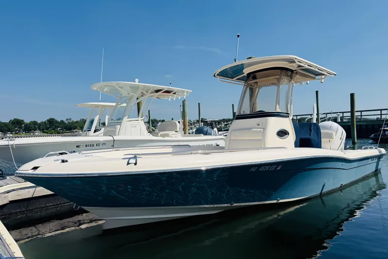 The Image of 2021 Grady-White 251 Coastal Explorer boat docked in marina under clear blue sky. - 1