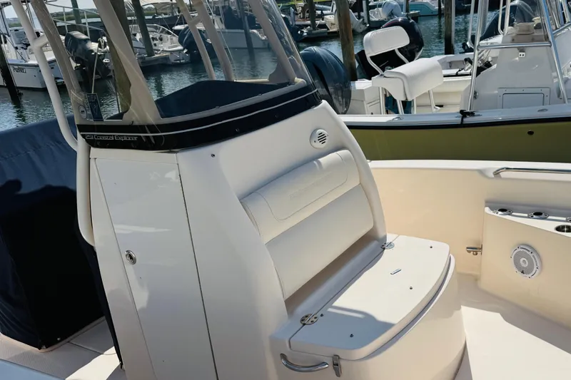 Slide: The Image of 2021 Grady-White 251 Coastal Explorer boat interior with seating and console at marina. - 4