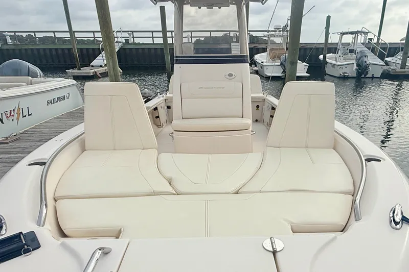 Slide: The Image of 2021 Grady-White 251 Coastal Explorer boat with cushioned seating at a marina. - 10