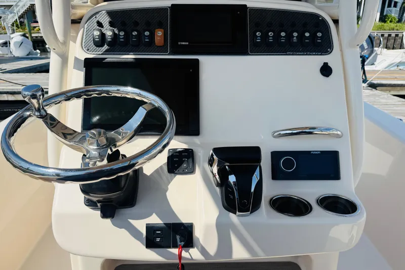 Slide: The Image of 2021 Grady-White 251 Coastal Explorer helm with steering wheel and control panel. - 7