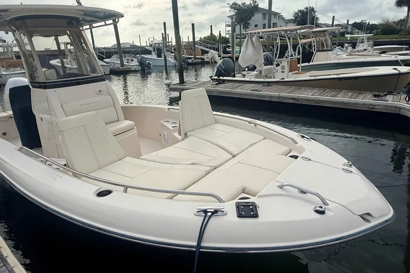 Slide: The Image of 2021 Grady-White 251 Coastal Explorer boat docked at marina, featuring spacious seating. - 9