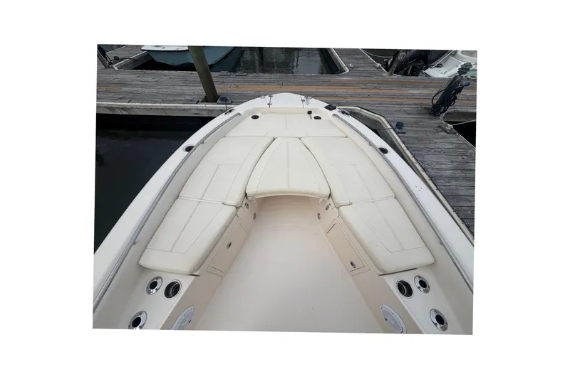 Slide: The Image of 2021 Grady-White 251 Coastal Explorer boat interior with cushioned seating at dock. - 16