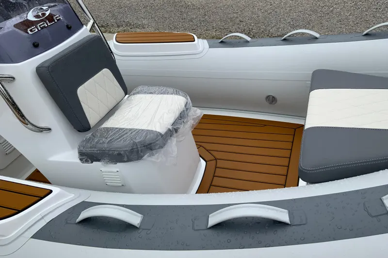 Slide: The Image of Interior of 2027 Gala V360 boat with cushioned seating and wooden flooring. - 5