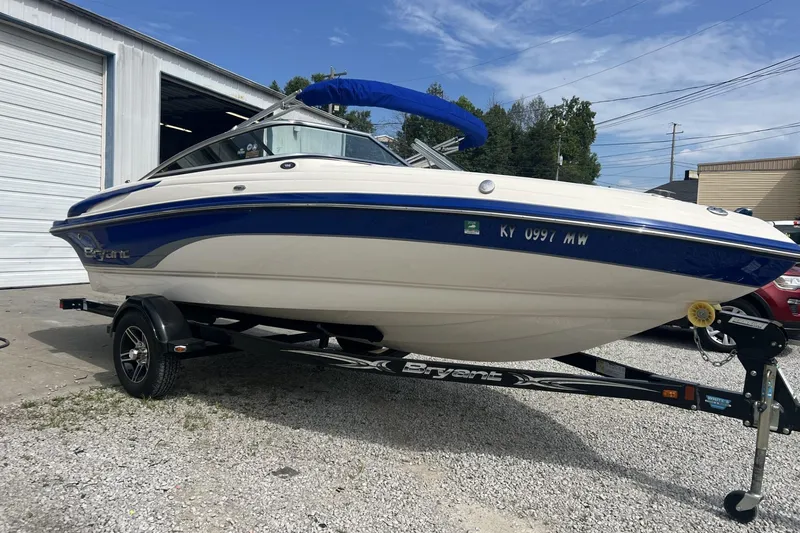 The Image of 2012 Bryant 196 boat on trailer, parked outside a garage. - 1