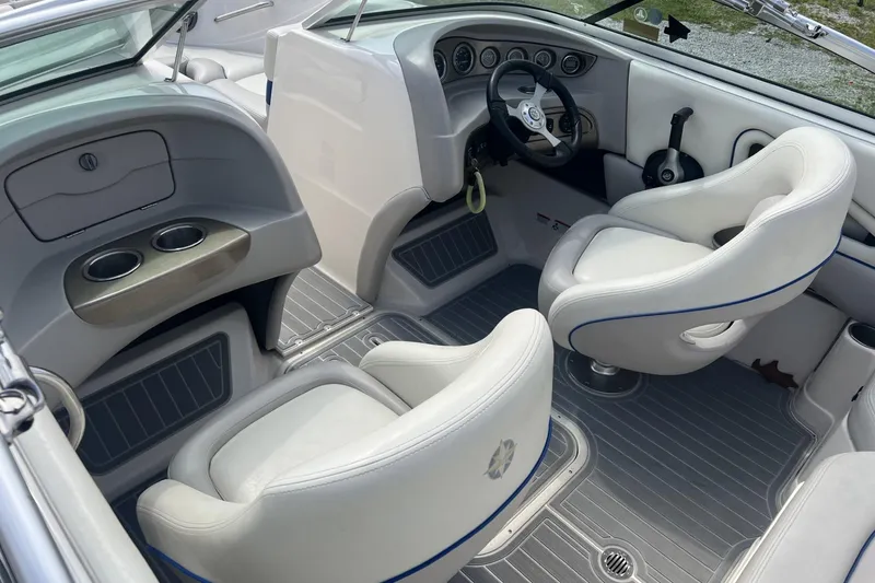 Slide: The Image of Interior of a 2012 Bryant 196 boat with white seating and dashboard controls. - 6