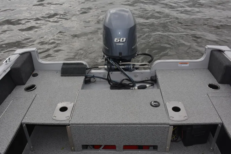 Slide: The Image of Manufacturer Provided Image: 2022 Starcraft Stealth 166 SC boat with 60 HP outboard motor on water. - 11