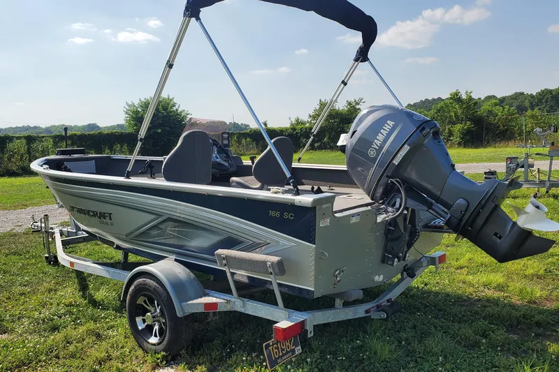 Slide: The Image of 2022 Starcraft Stealth 166 SC boat with Yamaha motor on trailer, parked on grass. - 1