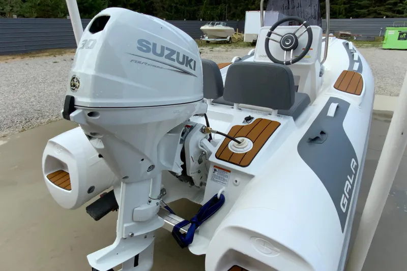 Slide: The Image of 2027 Gala V330 boat with Suzuki engine, featuring sleek design and modern controls. - 6