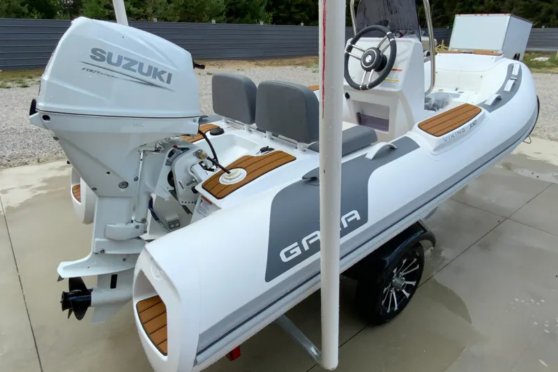 Slide: The Image of 2027 Gala V330 boat with Suzuki outboard motor on a trailer. - 5