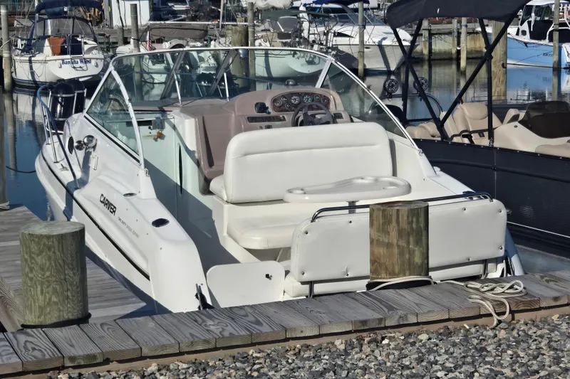 Slide: The Image of 1997 Carver 260 Mid Cabin Express boat docked at a marina. - 10