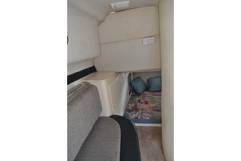 Slide: The Image of 1997 Carver 260 Mid Cabin Express interior with seating and cozy sleeping area. - 7