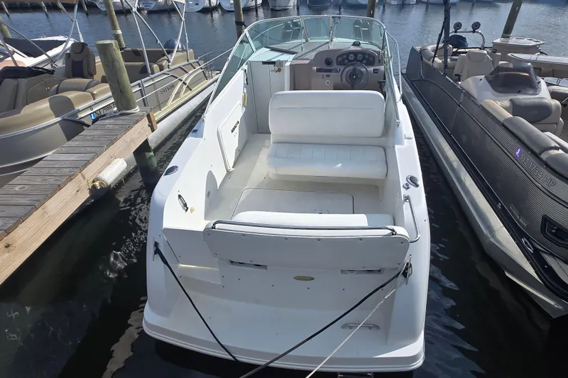 Slide: The Image of 1997 Carver 260 Mid Cabin Express boat docked at marina, rear view. - 9