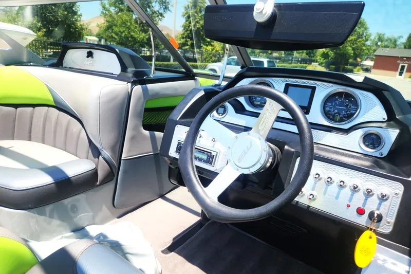 Slide: The Image of Interior of 2015 MB SPORTS F22 Tomcat boat with modern dashboard and steering wheel. - 2