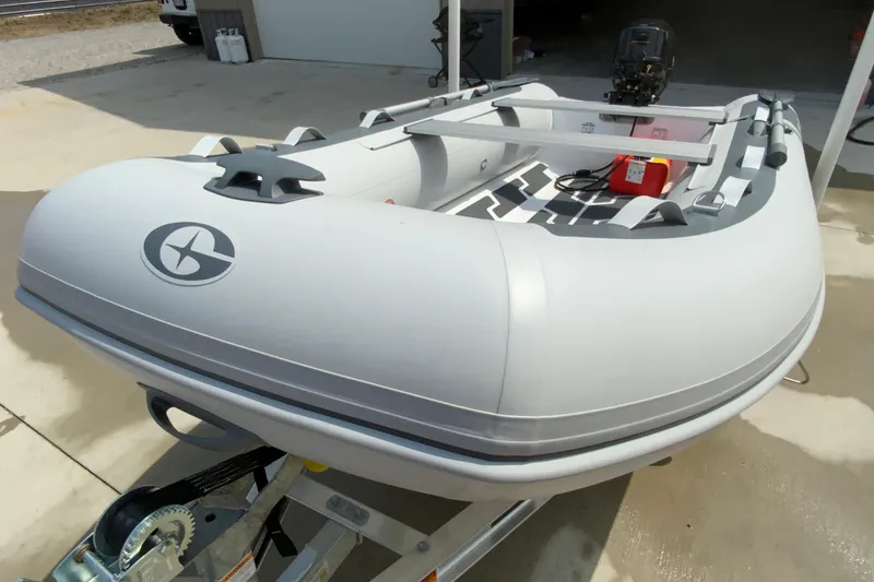 Slide: The Image of 2027 Gala A330D inflatable boat on trailer, outdoor setting. - 5