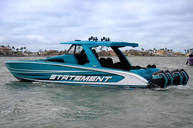 Slide: The Image of Manufacturer Provided Image: 2025 Statement 430 Tigress boat cruising on water with multiple engines. - 2
