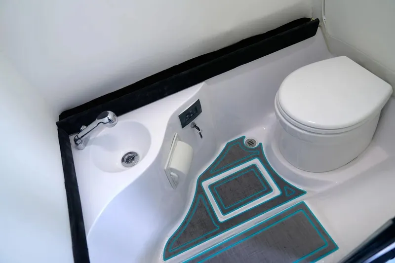 Slide: The Image of Manufacturer Provided Image: Compact bathroom in 2025 Statement 430 Tigress boat with toilet and sink. - 9