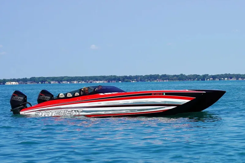 The Image of Manufacturer Provided Image: Red and black Statement 360 CAT boat cruising on a lake, 2026 model. - 0