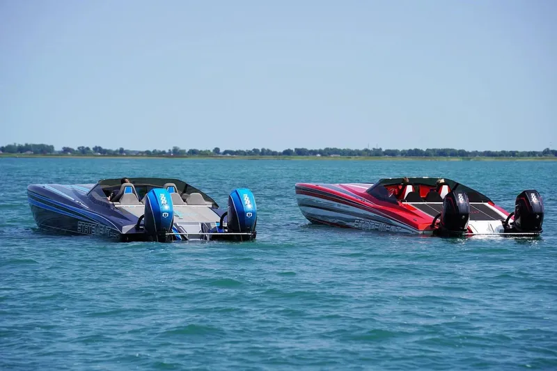 Slide: The Image of Manufacturer Provided Image: Two Statement 360 CAT boats on a calm lake, showcasing sleek design and powerful engines. - 5